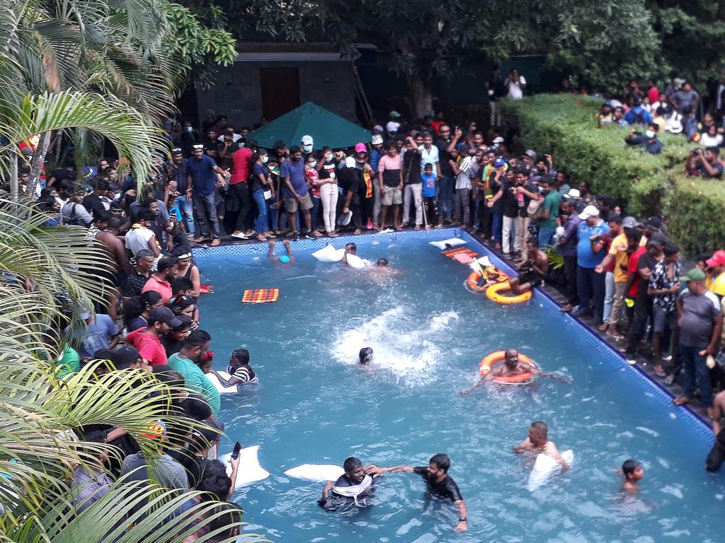 Protesters demanding the resignation of Sri Lanka’s President Gotabaya Rajapaksa swim in a pool inside the Presidential Palace compound. Picture: AFP