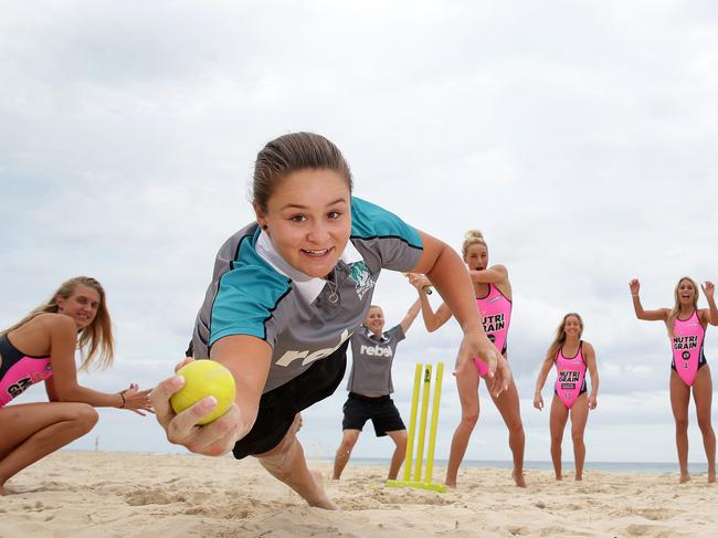 Ashley Barty (taking catch) and Brisbane Heat cricket players train with Nutri-Grain Ironwomen in Ash’s cricket days. Picture: Adam Head