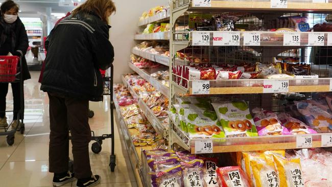 Customers gather in a food section of a supermarket in Tokyo on February 27, 2024. Japanese inflation slowed less than expected to two percent in January, data showed February 27, hitting the central bank's target and firming expectations of an end to its outlier negative rates policy. (Photo by Kazuhiro NOGI / AFP)