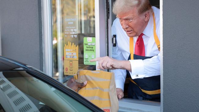 FEASTERVILLE-TREVOSE, PENNSYLVANIA - OCTOBER 20: Republican presidential nominee, former U.S. President Donald Trump works the drive-through line as he visits a McDonald's restaurant on October 20, 2024 in Feasterville-Trevose, Pennsylvania. Trump is campaigning the entire day in the state of Pennsylvania. Trump and Democratic presidential nominee Vice President Kamala Harris continue to campaign in battleground swing states ahead of the November 5th election.   Win McNamee/Getty Images/AFP (Photo by WIN MCNAMEE / GETTY IMAGES NORTH AMERICA / Getty Images via AFP)