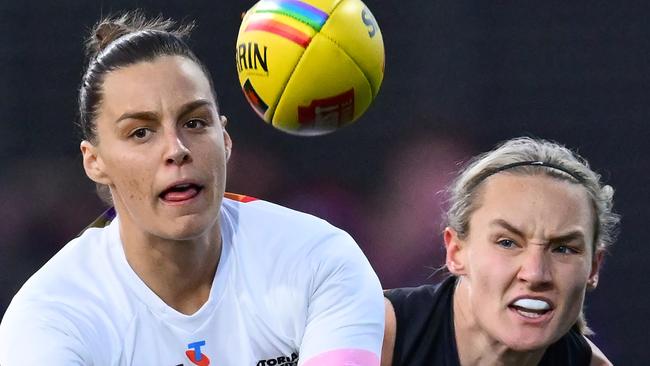 MELBOURNE, AUSTRALIA - OCTOBER 11: Deanna Berry of the Bulldogs handballs whilst being tackled during the round seven AFLW match between Western Bulldogs and Essendon Bombers at Mission Whitten Oval, on October 11, 2024, in Melbourne, Australia. (Photo by Quinn Rooney/Getty Images)