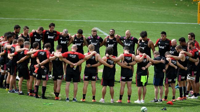 Canterbury Crusaders players and staff pause during their Captain's Run training session for two minute's silence, a week on from the Christchurch terror attack, at 11.32am Sydney time, at The Scots College, in Sydney. Picture: AAP 