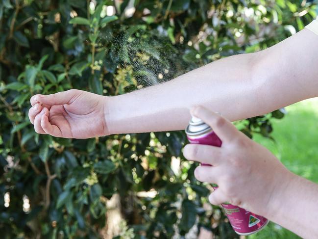 A Liverpool resident sprays mosquito repellent in 2019. Picture: Carmela Roche