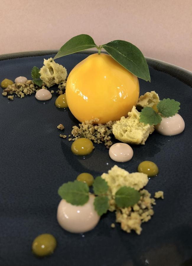 Textbook Boulangerie Patisserie dessert of mandarin mousse with a mandarin and basil compote pistachio sponge and crumble, mandarin gel and callebauet gold chocolate cream.