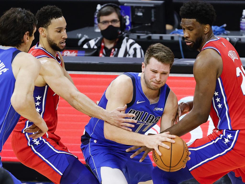 Ben Simmons and Joel Embiid of the Philadelphia 76ers guard Luka Doncic.