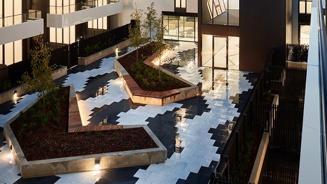 Courtyard paving design resembles tyre tread marks to embrace the site’s history as a tyre factory.