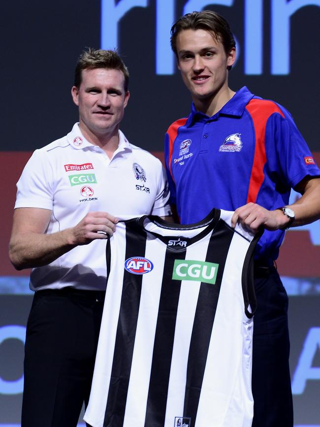 Nathan Buckley presents Darcy Moore with his jumper at the 2014 AFL draft. Picture: Stephen Harman