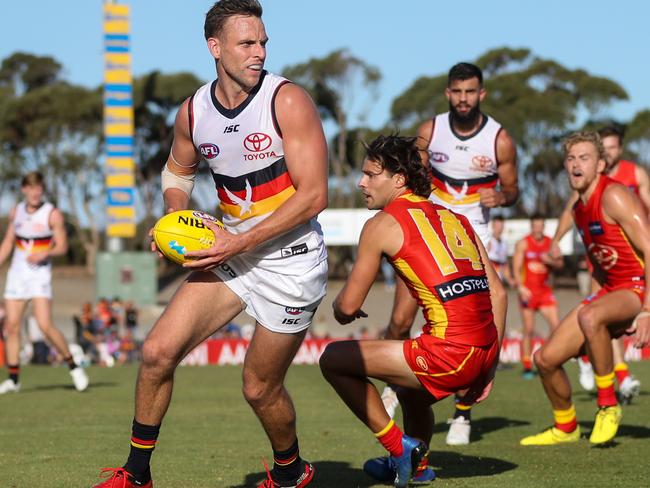 ADELAIDE, AUSTRALIA - MARCH 06: Brodie Smith of the Crows evades Lachie Weller of the Suns during the 2020 Marsh Community Series match between the Adelaide Crows and the Gold Coast Suns at Flinders University Stadium on March 06, 2020 in Adelaide, Australia. (Photo by AFL Photos)