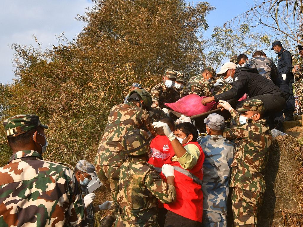 Rescuers carry the body of a victim who died in a plane crash in Nepal, in the Himalayan country's deadliest aviation disaster in three decades. Picture: AFP