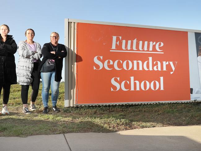 Armstrong Creek parents and residents Jacky Basset, left, Lauren Piechota and Sherryn Vessey at the site earmarked for a secondary school. Picture: Alison Wynd