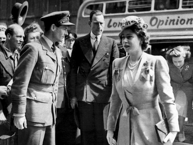 Princess Elizabeth (later Queen Elizabeth II) with Princess Margaret (right) arriving at Palace Theatre in London and Captain Peter Townsend (left) looking on, 1946.