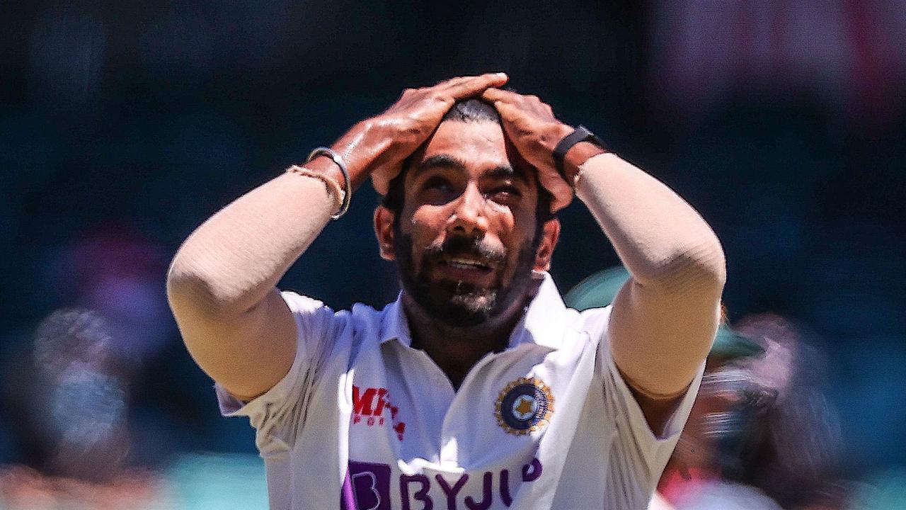 India's Jasprit Bumrah reacts after the catch of Australia's captain Tim Paine was dropped.