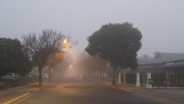 Thick fog in the western suburbs just after 7am on Saturday morning. Photo: Greg Barila / The Advertiser.