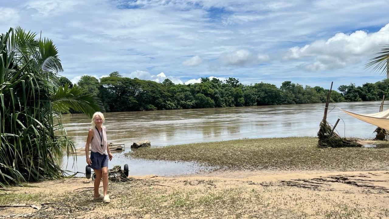 Camille O'Sullivan, a Catholic Education teacher, standing on the banks of the Herbert River outside her flood-ravaged home in Cordelia. Picture: Cameron Bates