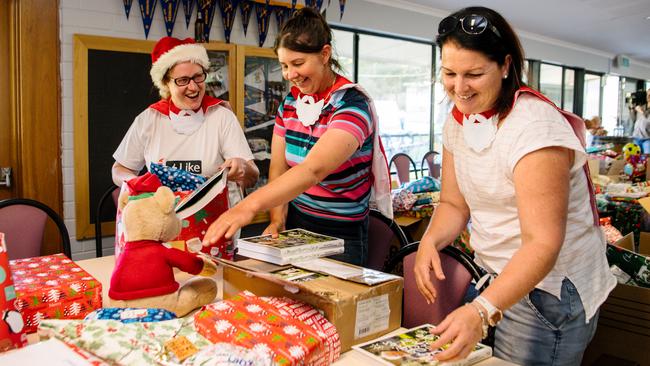 Katrina Harmann, Esther Cruckshank and Keri Tilbrook wrap presents at an event organised by Lobethal Bushfire Recovery volunteers. Picture: Morgan Sette