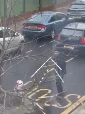 The driver eventually managed to get a hold of one of the ladders. Picture: Twitter @CrimeLdn