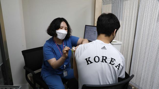 A member of the South Korean Olympic judo team receives the first dose of the Pfizer-BioNTech during a vaccination program for the country's Tokyo Olympics team. Picture: AFP