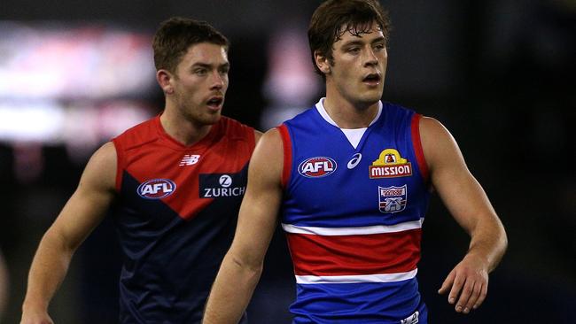 Josh Dunkley of the Bulldogs (right) and brother Kyle Dunkley of the Demons during the Round 17 AFL match between the Western Bulldogs and the Melbourne Demons at Marvel Stadium in Melbourne, Sunday, July 14, 2019.  (AAP Image/Hamish Blair) NO ARCHIVING, EDITORIAL USE ONLY