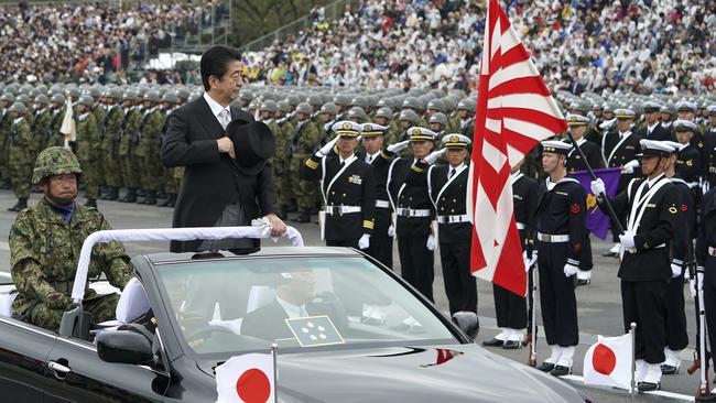 Japanese Prime Minister Shinzo Abe reviews troops in Asaka yesterday. Picture: AP