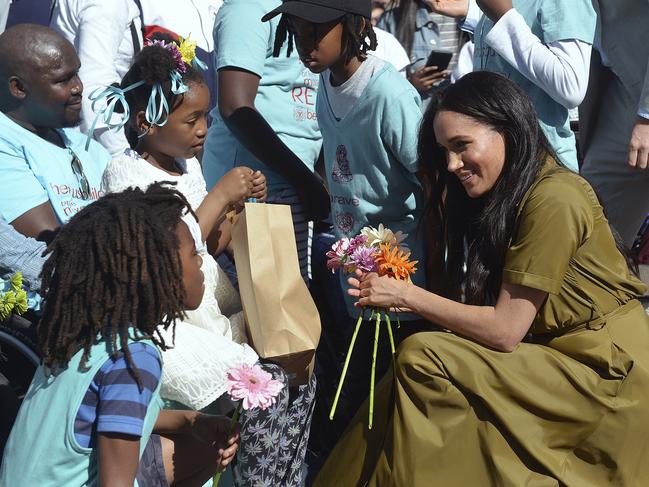 Prince Harry, and Meghan, the Duchess of Sussex, meet local children during a walkabout in Bo-Kaap, in Cape Town, South Africa. Picture: Courtney Africa/African News Agency/AP