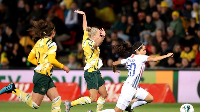 Tameka Yallop (centre) tackles Chile’s Daniela Zamora at Coopers Stadium in 2019. Picture: James Elsby / AAP