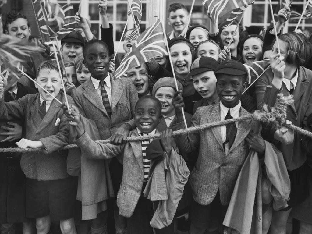 A crowd of children waving flags as seen in the Netflix doco. The photo was taken at a royal engagement for Queen Mary, wife of King George V, in 1938. Picture: Reg Speller/Fox Photos/Hulton Archive/Getty Images