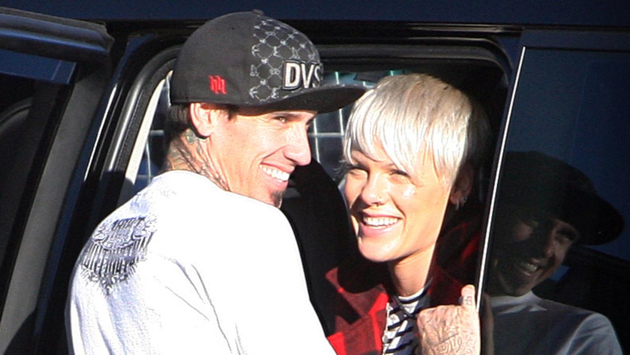 Musician Pink and Husband Carey Hart kiss in the back of a 4WD during Hart's motocross show at the Entertainment Quarter in Sydney.