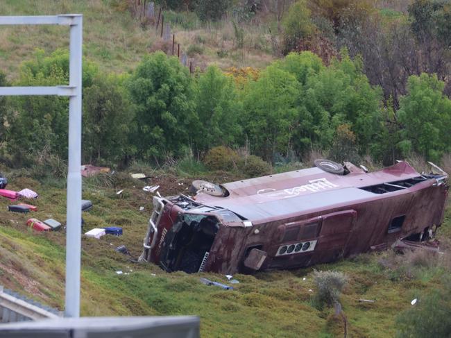 MELBOURNE, AUSTRALIA- SEPTEMBER 21 A school bus carrying 32 people has flipped on the Western Highway in Bacchus Marsh. Police are investigating the crash between a school bus and a truck that occured at around 3.15am. Picture: Brendan Beckett