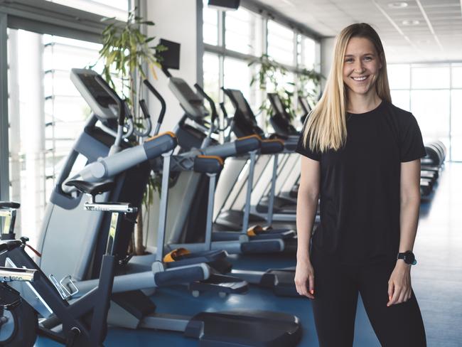 Attractive woman in an indoor gym, one person only. Professional fitness instructor. Helping people get fit and exercise well is my professional occupation. Portrait photo.