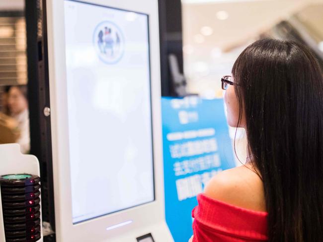 A Chinese customer experiences a facial recognition payment system. Picture: AFP