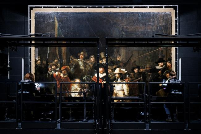 Technicians work to remove varnish from Rembrandt's masterpiece "the Night Watch" at the Rijksmuseum in Amsterdam