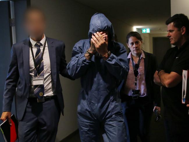 Siar Munshizada being arrested at an Olympic Park unit block.