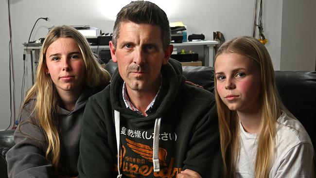 Lee Lovell and his daughters Scarlett and Kassie at their North Lakes home. Picture: Lyndon Mechielsen/Courier Mail