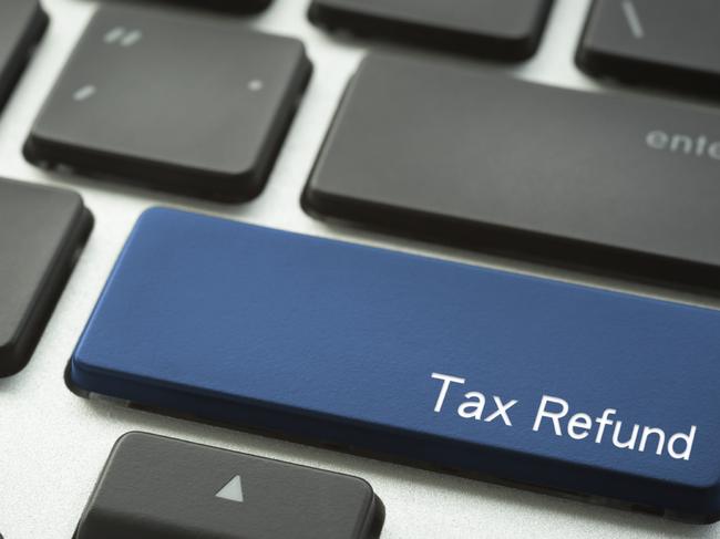 Close up computer keyboard focus on a blue button with typographic word Tax Refund.