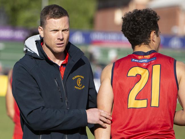 Flinders Park Coach Luke Ivens with #21 player Anthony Laudato Adelaide Footy League division three Grand Final Golden Grove v Flinders Park at Norwood Oval. Photographer Emma Brasier