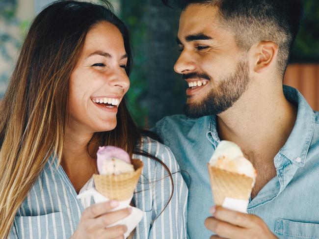 Happy young couple having date and eating ice cream