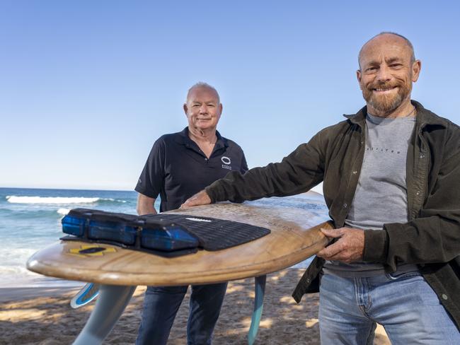 Lindsay Lyon and surfer Tom Carroll at Avalon Beach with the shark repellent boards. Lindsay runs the Warriewood company which uses this technology to prevent shark attacks. He is looking for funds to pilot a beach barrier repellent which would be a kinder way to keep sharks at bay than shark nets. Image Matthew Vasilescu