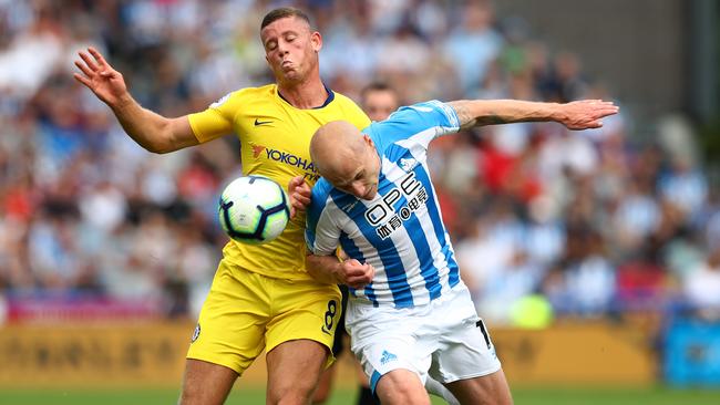 Huddersfield’s Aaron Mooy gets his head to the ball ahead of Chelsea’s Ross Barkley last weekend.