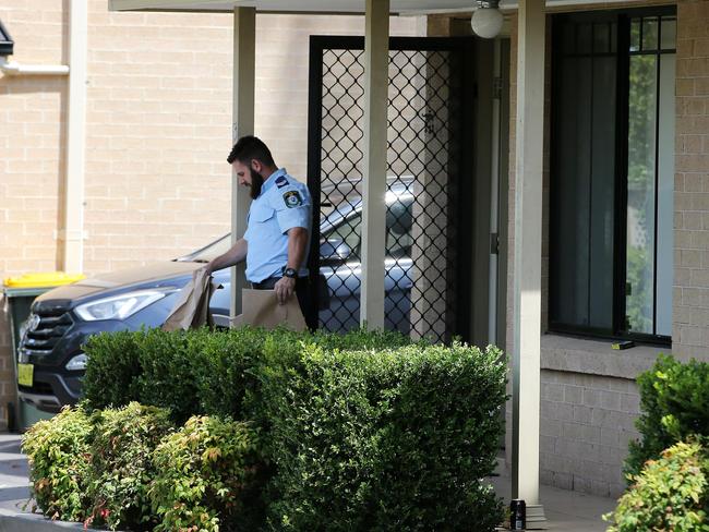 Police remove evidence bags from the Quakers Hill unit where David Peterson lived. Picture: Stephen Cooper