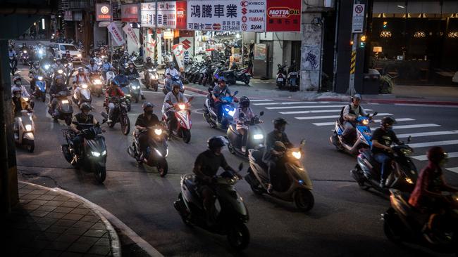 Scooters hit the road during peak hour in Taipei on Tuesday. Picture: Getty Images