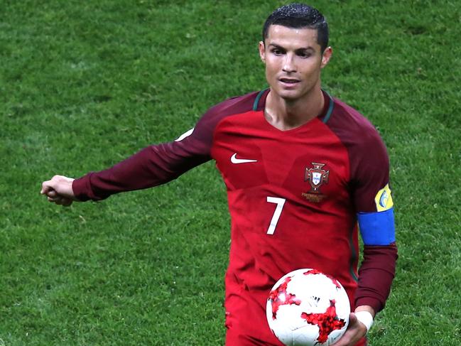 Portugal's forward Cristiano Ronaldo holds the ball during the 2017 Confederations Cup semi-final football match between Portugal and Chile at the Kazan Arena in Kazan on June 28, 2017. / AFP PHOTO / Roman Kruchinin