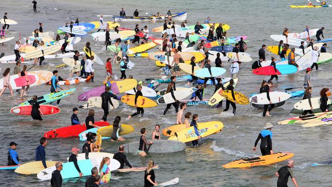 Crowds at Brighton paddle out to sea to protest the drilling for oil in the Great Australian Bight. Picture; AAP/Emma Brasier.