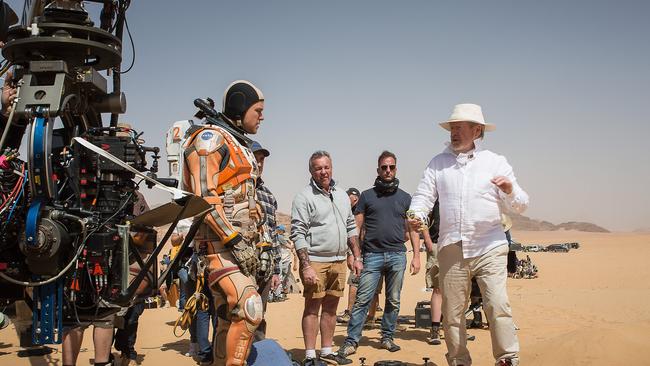 On location in Jordan, director Ridley Scott reviews a scene with Matt Damon for The Martian.