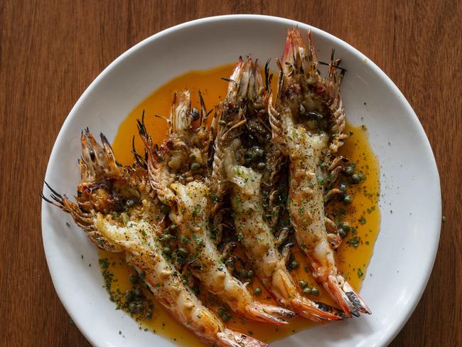 Lightly charred barbecued king prawns coated in prawn butter and scattered with capers. Picture: Russell Shakespeare