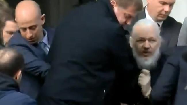 Assange was removed from the Ecuadorian embassy, yelling “resist”. Picture: Ruptly