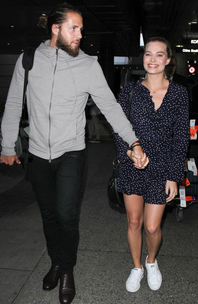 Margot was wearing a navy blue Realisation Par dress, along with white sneakers.