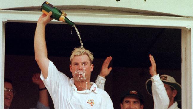 Shane Warne pours a bottle of champagne over his head in 1997.