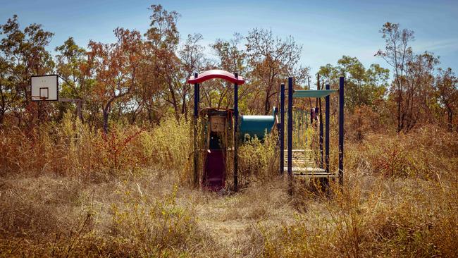 An overgrown playground at Yikarrakkal. The community school was intermittently running in 2022 but is now not in use. Picture: Rebecca Parker