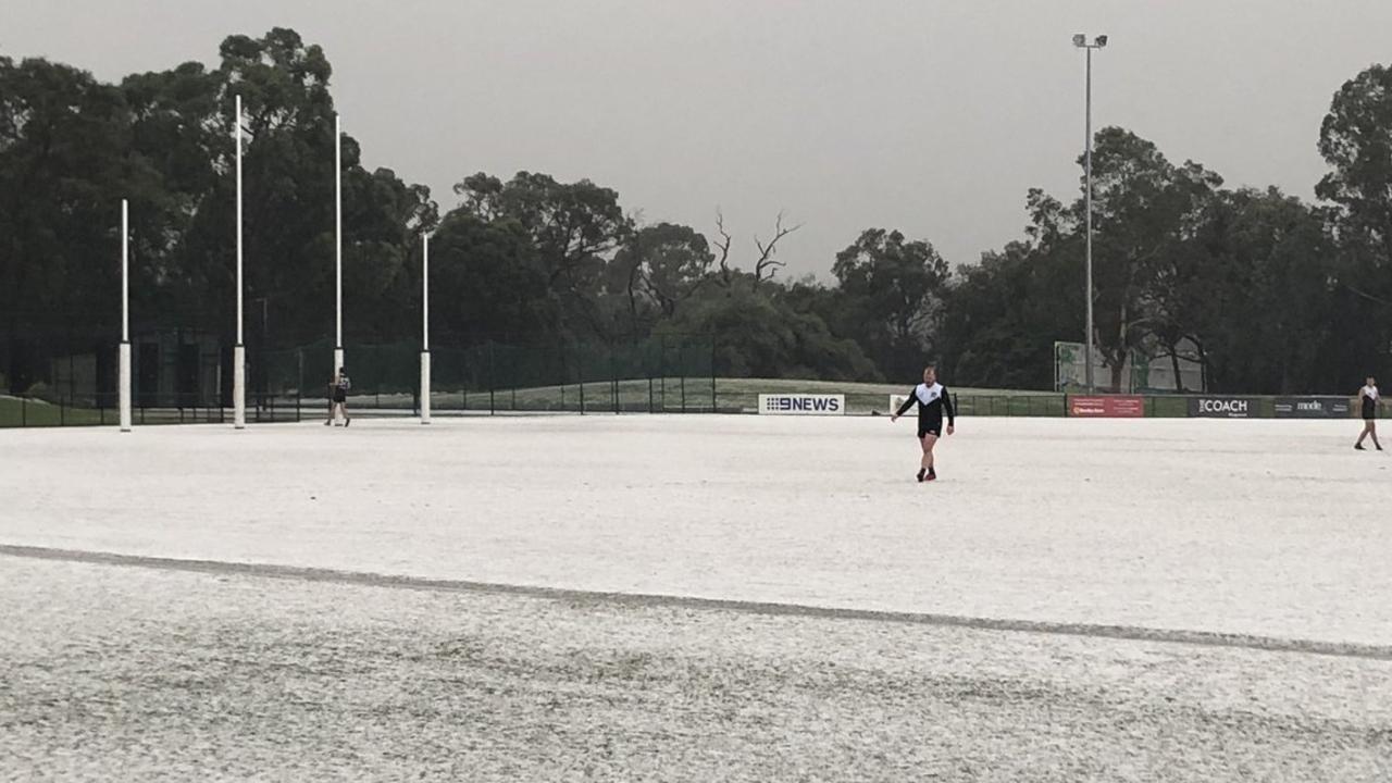 Suburban footy players in Ringwood, Victoria had to deal with a freak hail storm on Saturday. Photo: @MichaelSukkarMP