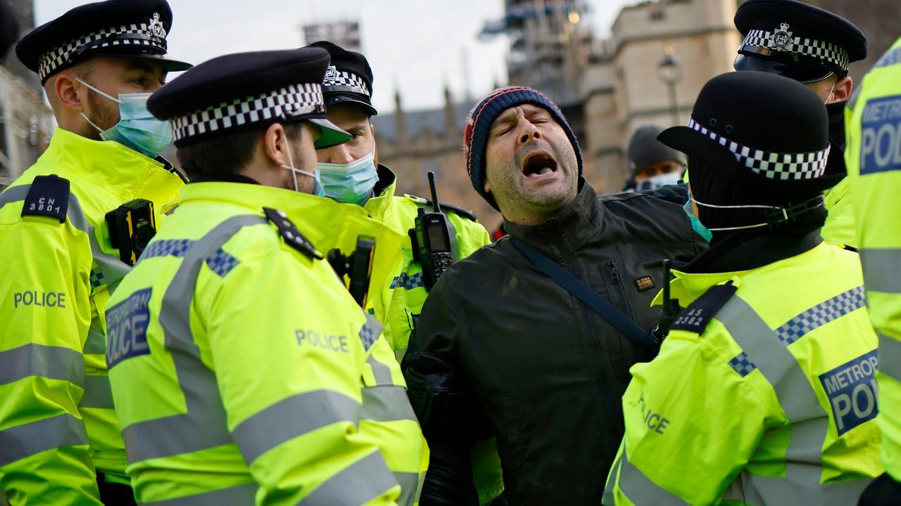 A protester is arrested by police during an anti-lockdown demonstration outside Parliament in central London. Picture: Tolga Akmen / AFP